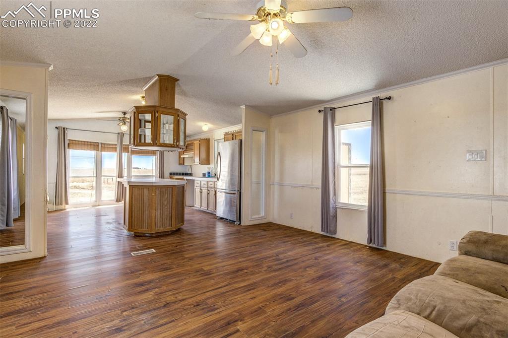 36210 Heavenly View Yoder, CO 80864 - Photo 12 of 42 a view of kitchen with refrigerator and wooden floor