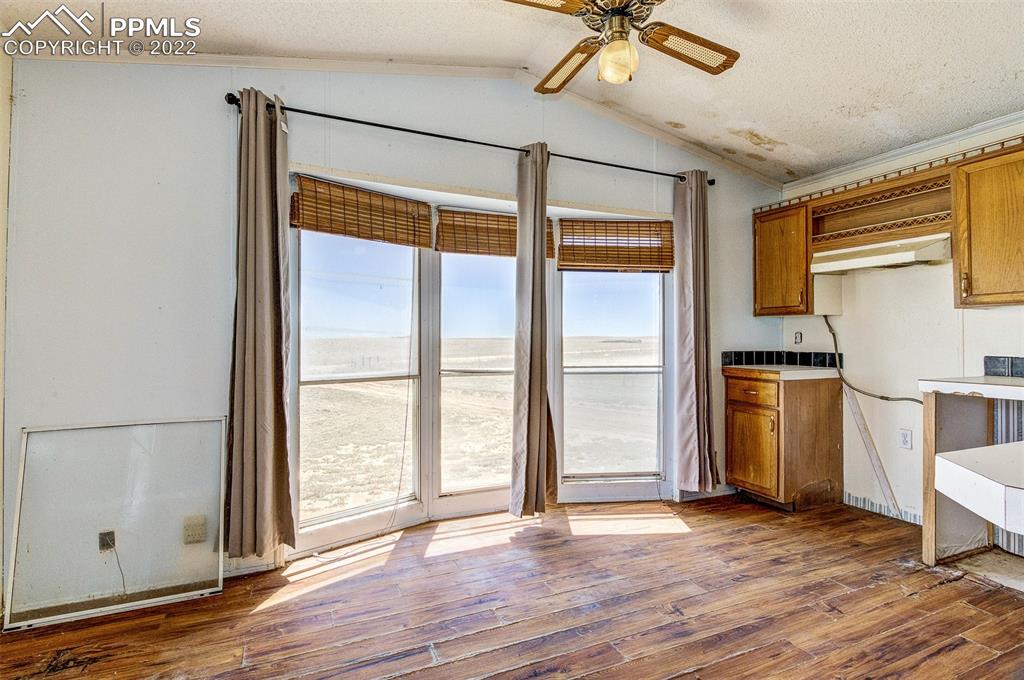 36210 Heavenly View Yoder, CO 80864 - Photo 14 of 42 a view of an empty room with a window and wooden floor