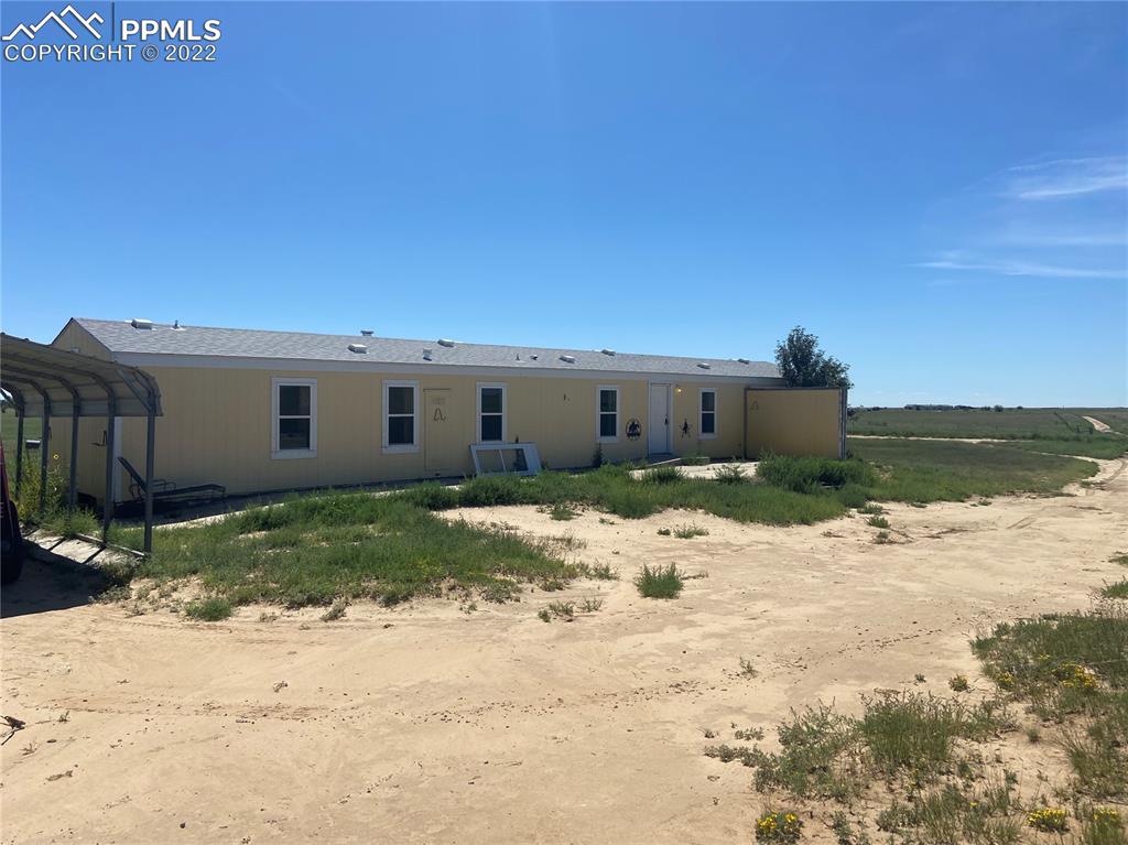 36210 Heavenly View Yoder, CO 80864 - Photo 6 of 42 a front view of a house with a yard