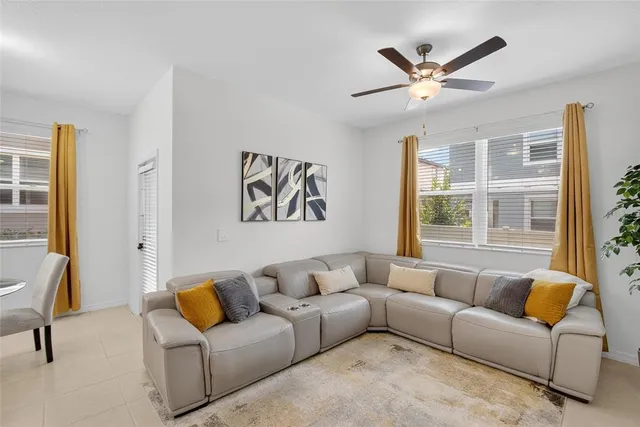 a view of room with a ceiling fan and a window
