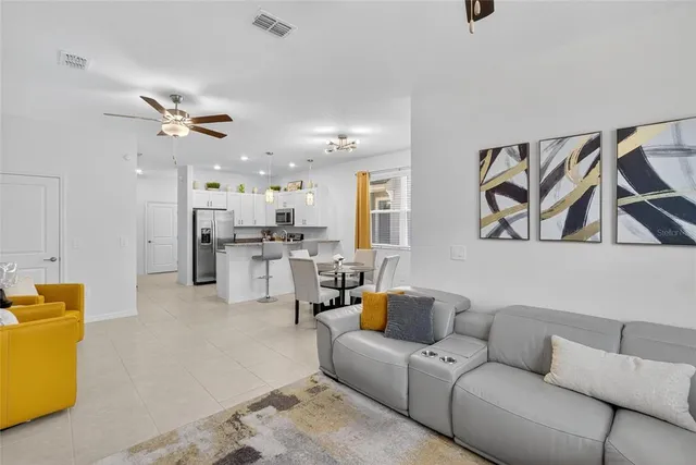 a bedroom with a large bed and a ceiling fan