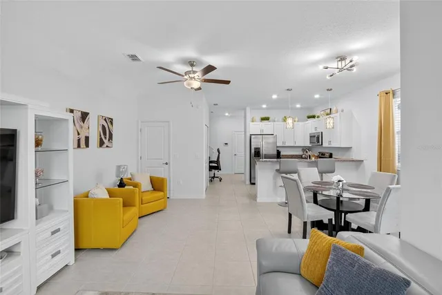 a bedroom with a bed and a ceiling fan