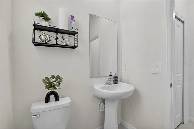 a kitchen with a sink and a couch with white walls