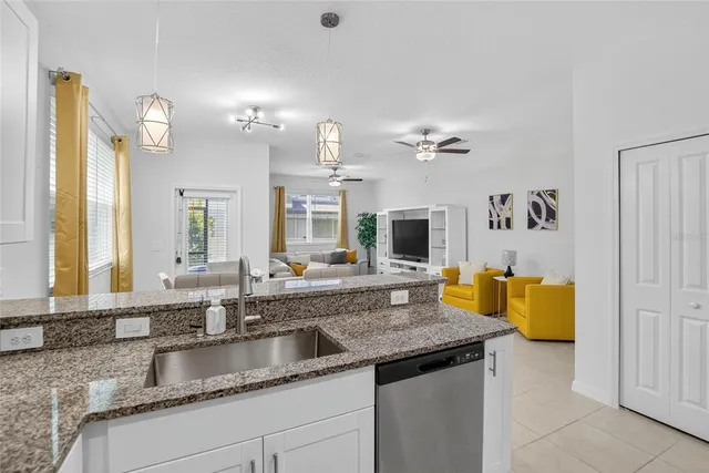 a living room with furniture and kitchen view