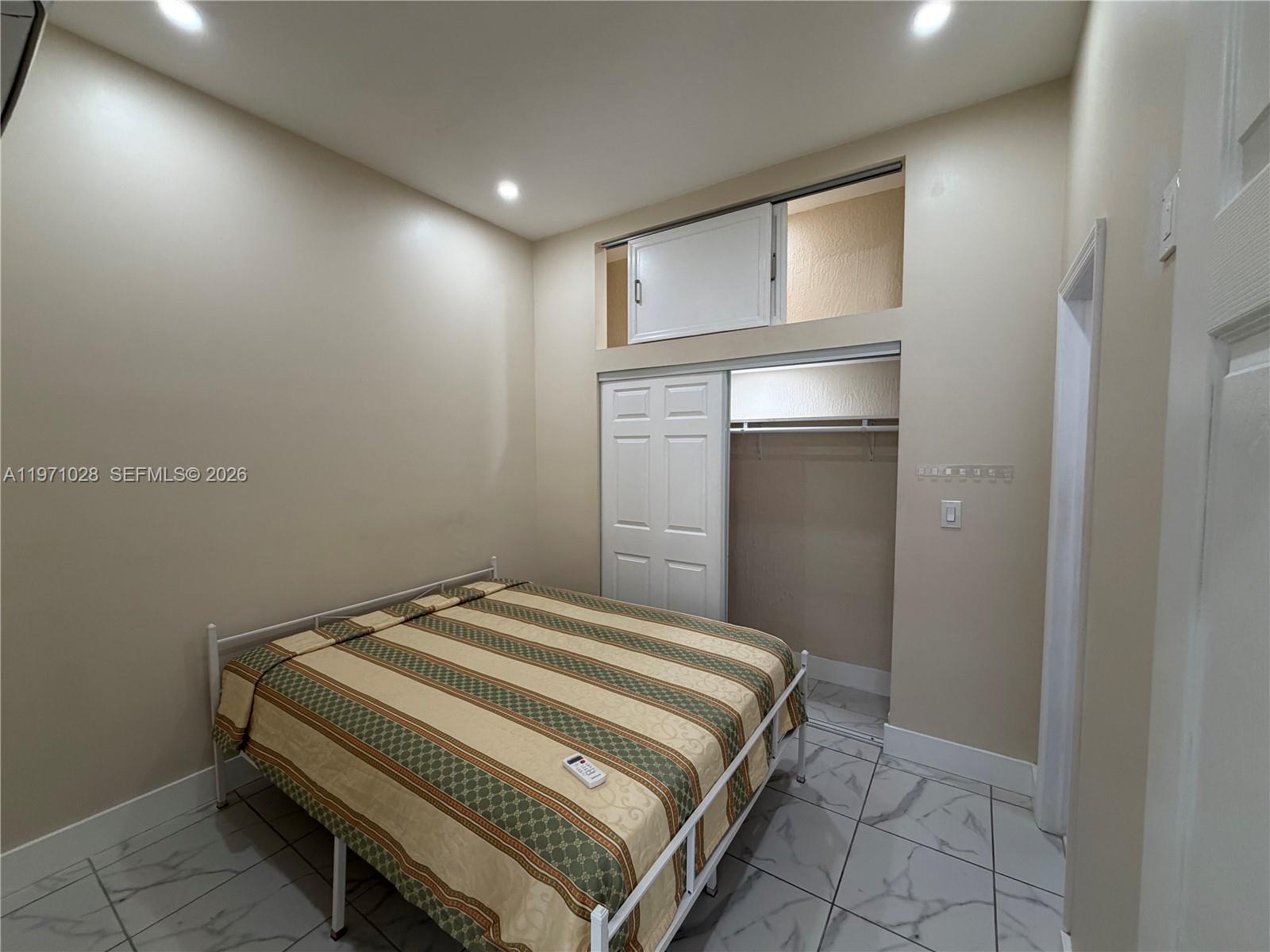 18255 Southwest 145th Avenue, Unit BACK Miami, FL 33177 - Photo 14 of 15 a bedroom with a bed and a window