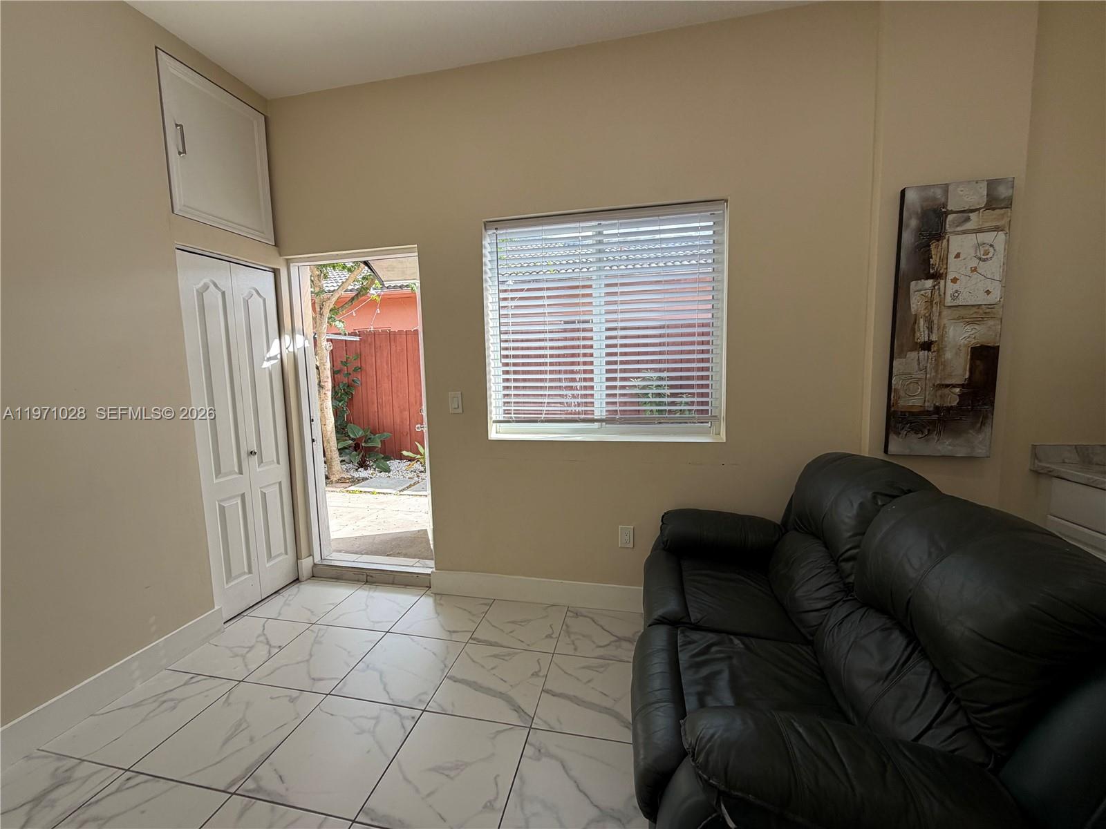 18255 Southwest 145th Avenue, Unit BACK Miami, FL 33177 - Photo 6 of 15 a living room with furniture and a window