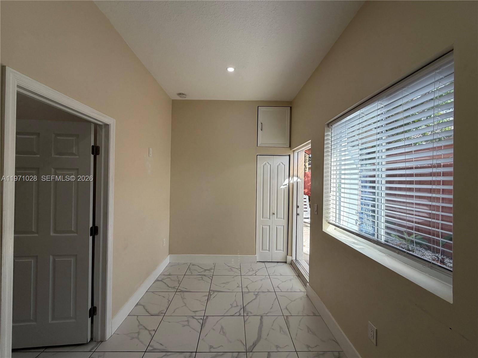 18255 Southwest 145th Avenue, Unit BACK Miami, FL 33177 - Photo 7 of 15 a view of an entryway with a window