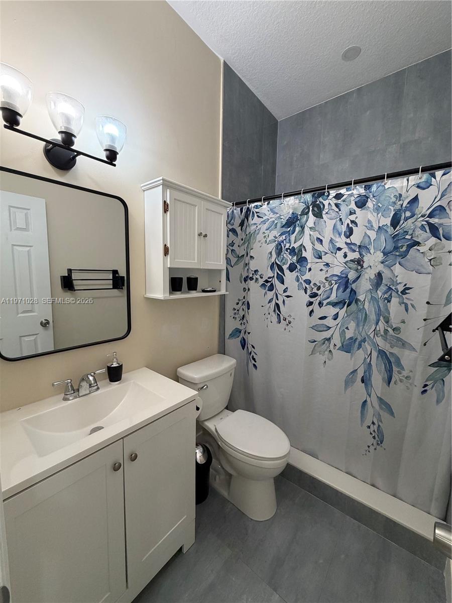 18255 Southwest 145th Avenue, Unit BACK Miami, FL 33177 - Photo 9 of 15 a bathroom with a sink toilet and shower