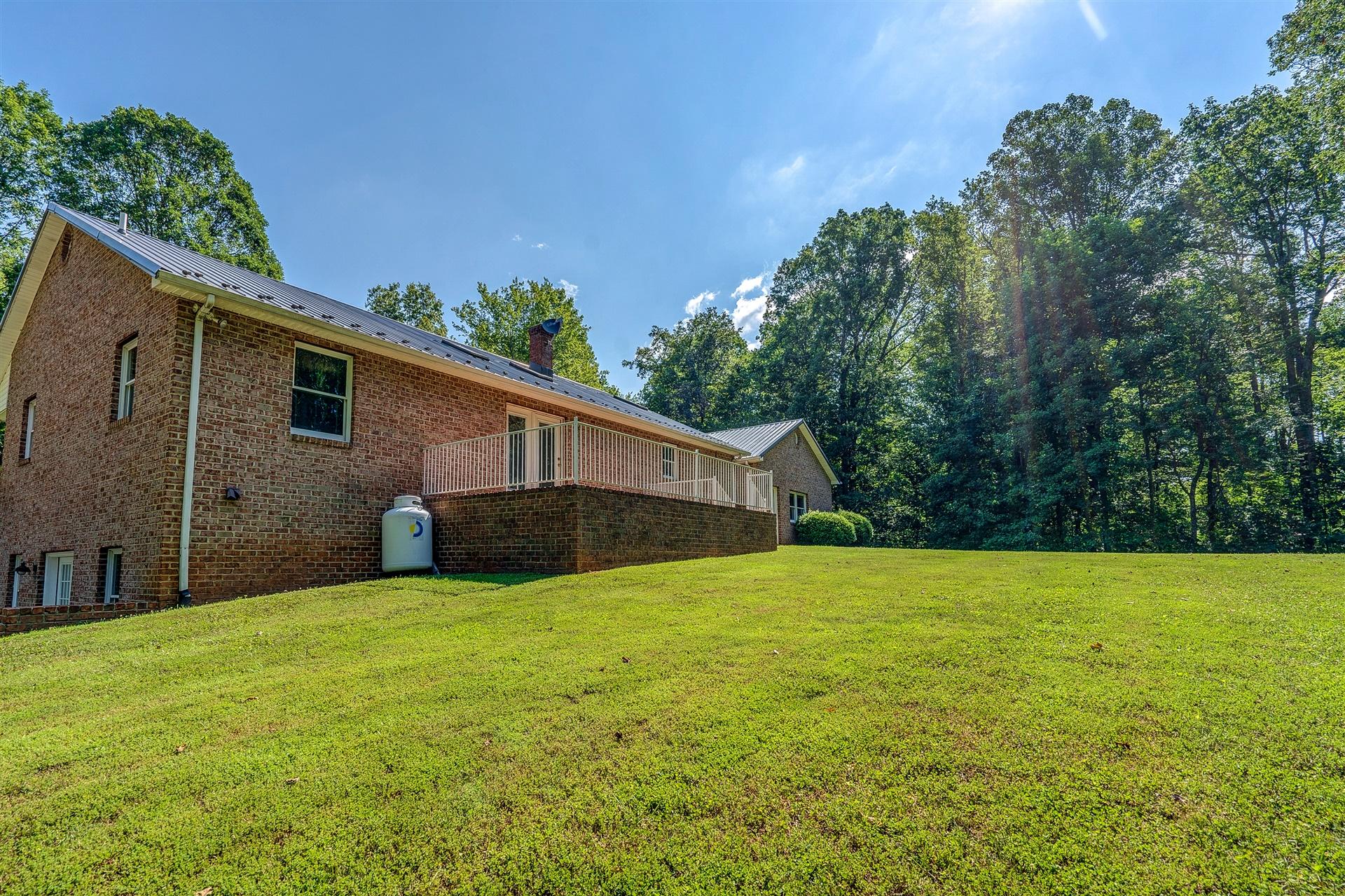 414 Thompson Ridge Circle Ferrum, VA 24088 - Photo 33 of 33 a backyard of a house with lots of green space