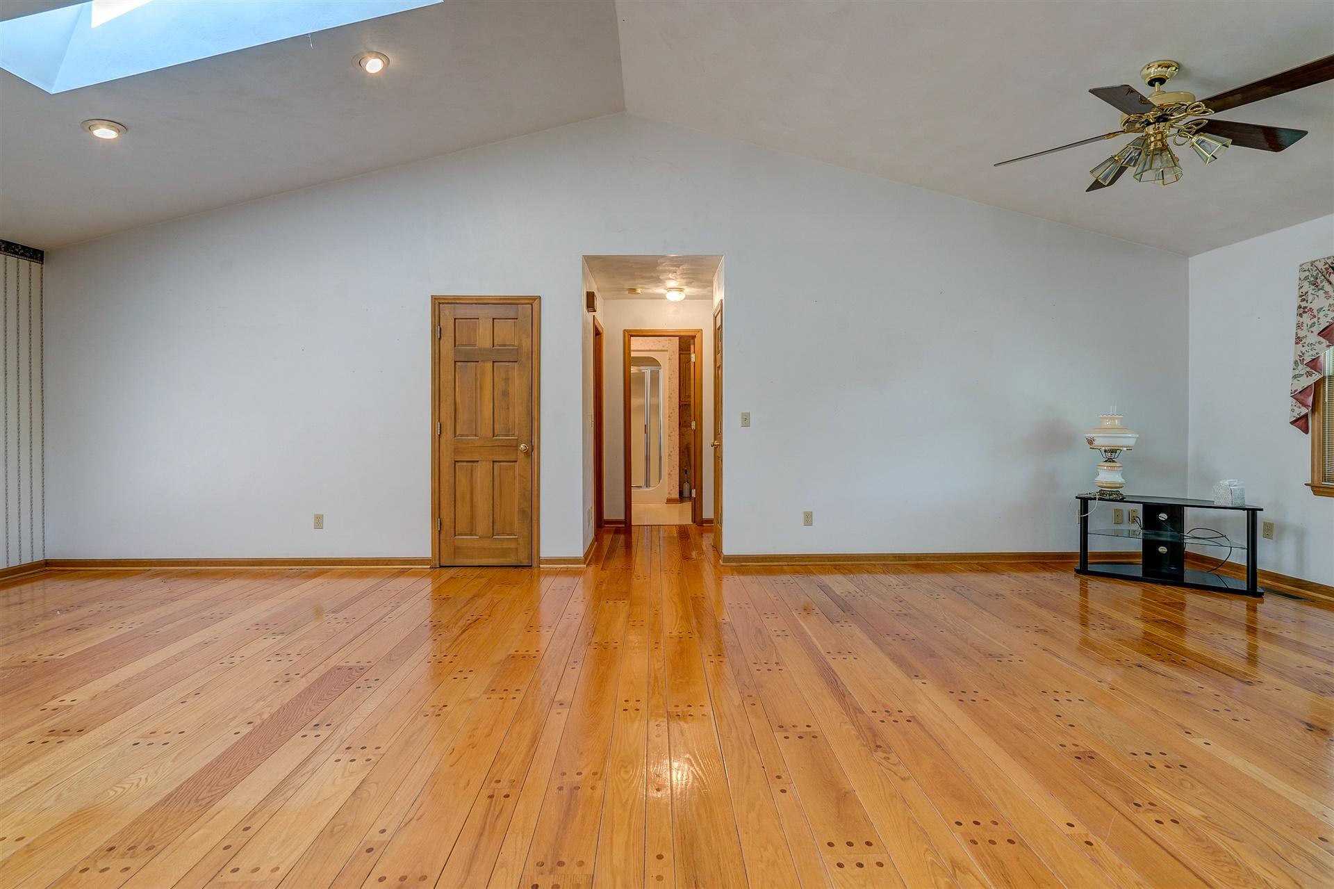 414 Thompson Ridge Circle Ferrum, VA 24088 - Photo 10 of 33 a view of empty room with wooden floor and a ceiling fan
