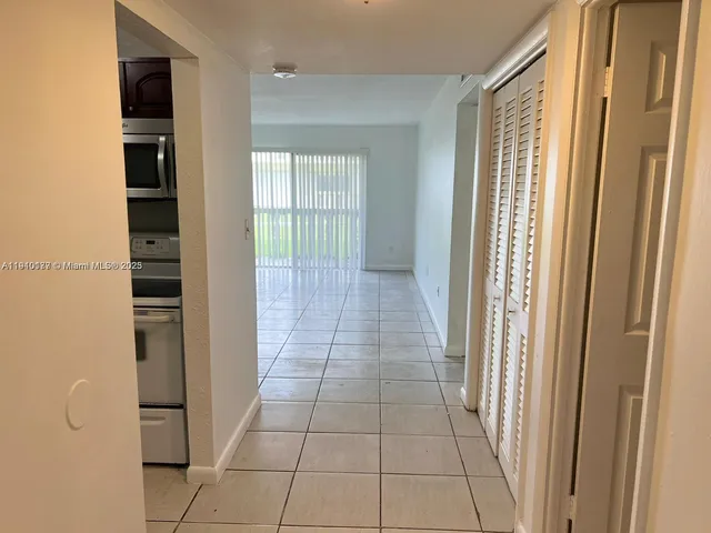 a view of a livingroom with an empty space and a window
