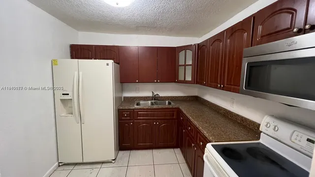 a kitchen with wooden cabinets and a stove top oven