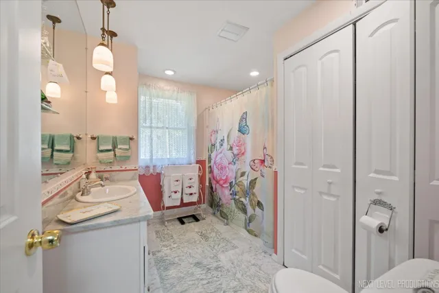 a bathroom with a sink vanity mirror and shower