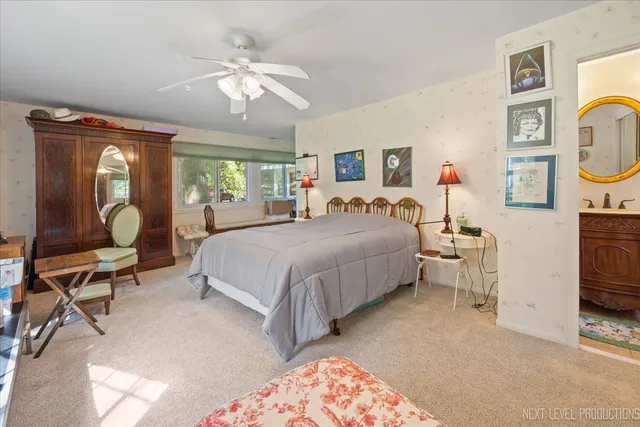 a bedroom with a bed a couch and dresser