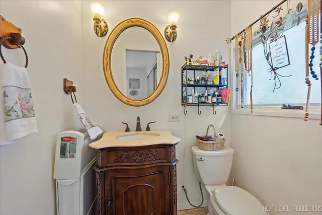 a bathroom with a toilet a sink and a mirror