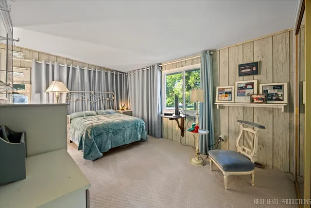 a bedroom with a bed and a chair