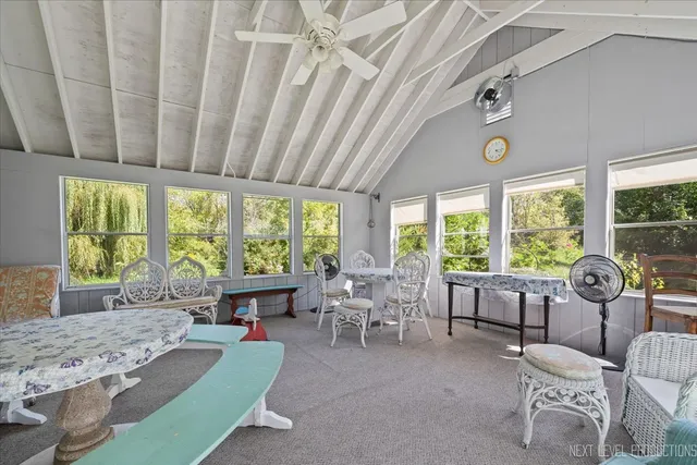 a living room with furniture and large windows