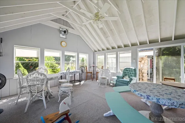a living room with furniture and large windows