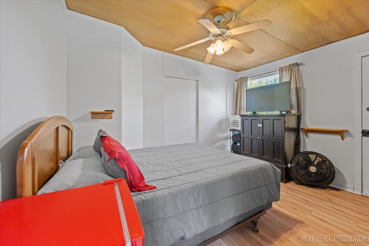 7N384 Whispering Willows Street St. Charles, IL 60174 - Photo 32 of 48 a bedroom with a bed and a chandelier