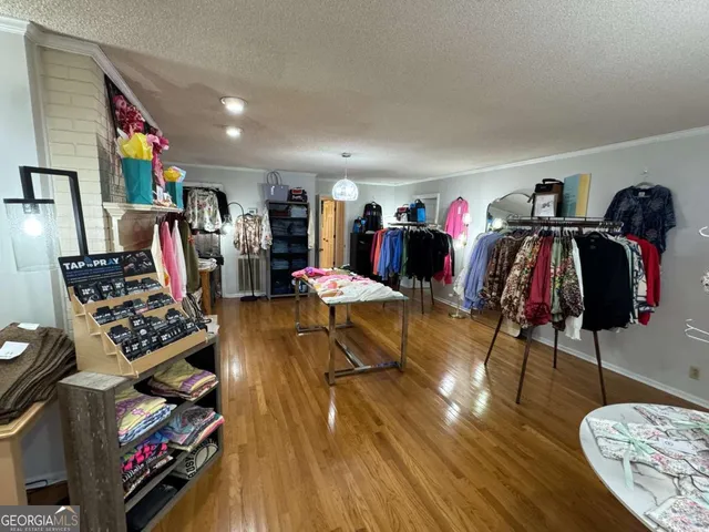a view of a play room with furniture and wooden floor