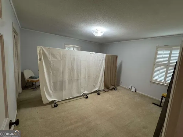 a living room with couches and kitchen view with wooden floor