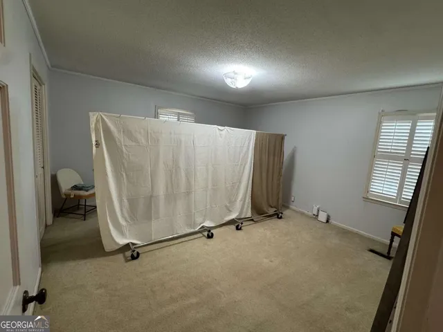 a living room with couches and kitchen view with wooden floor