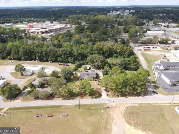 an aerial view of a house with a yard and lake view