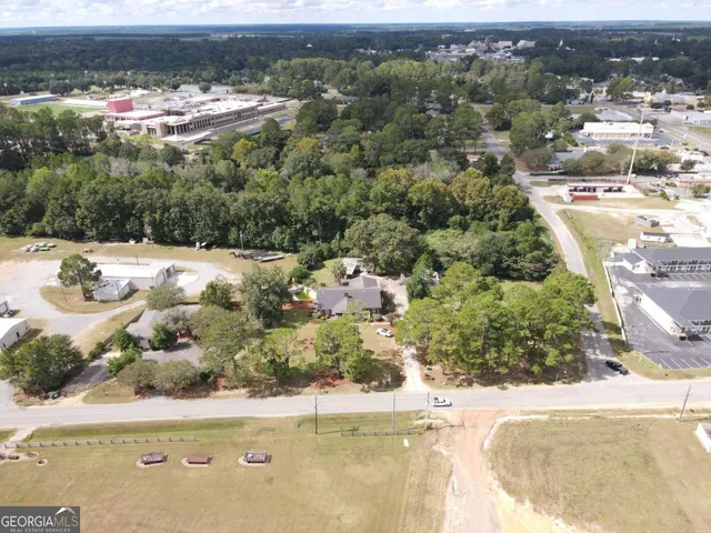 an aerial view of a house with a yard and lake view