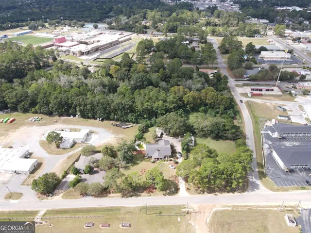 an aerial view of a house with yard and street