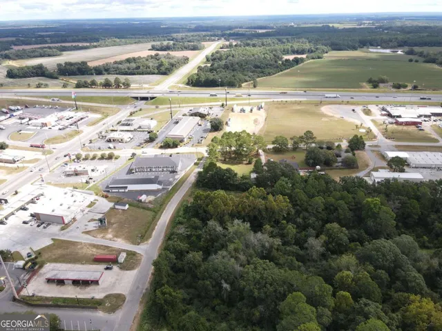 a view of a patio with a table and chairs under an umbrella
