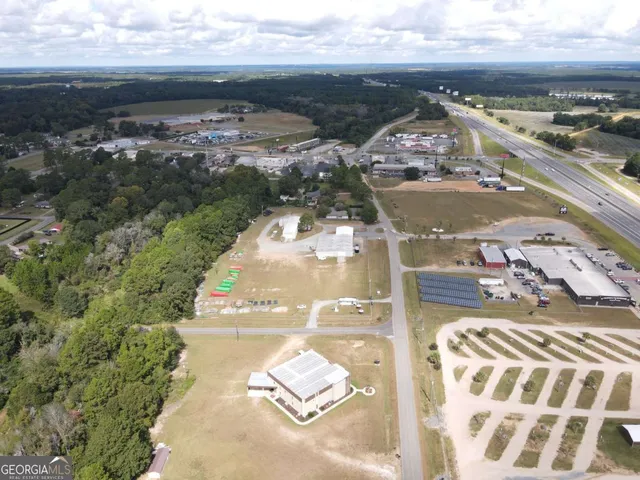 a view of a house with a yard and tree s