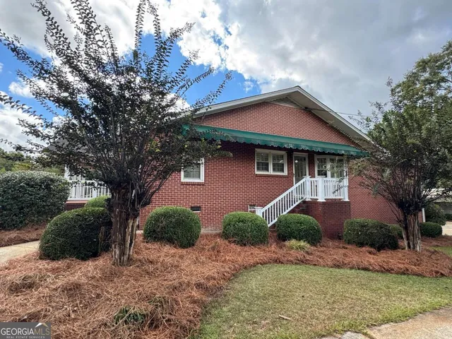 a front view of a house with garden