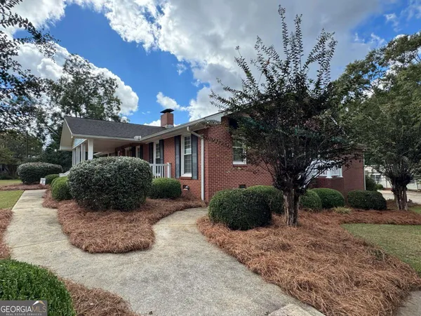 a view of a house with a yard and tree s
