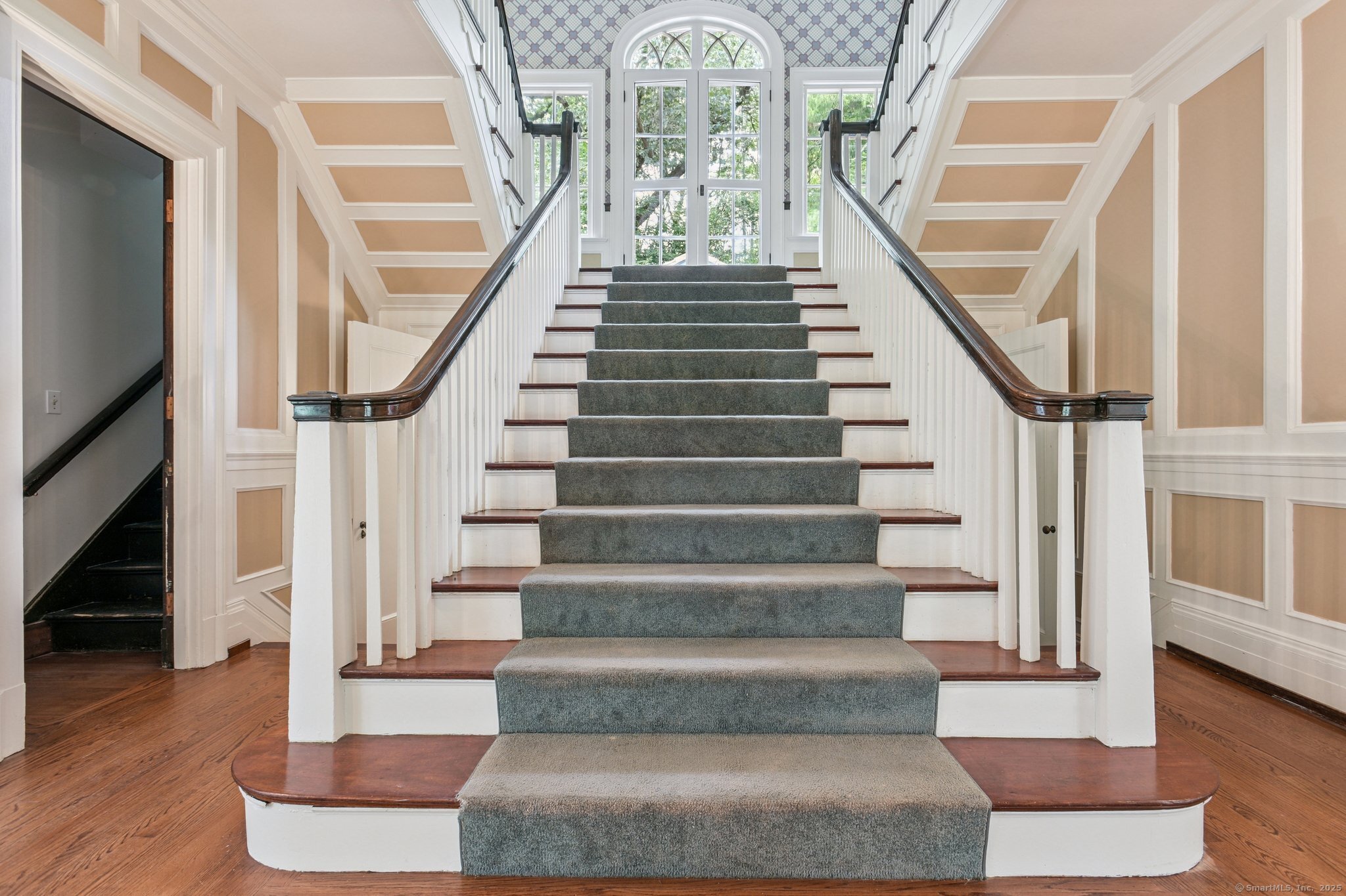 1056 Whitney Avenue Hamden, CT 06517 - Photo 20 of 40 a view of staircase with white walls windows and a chandelier