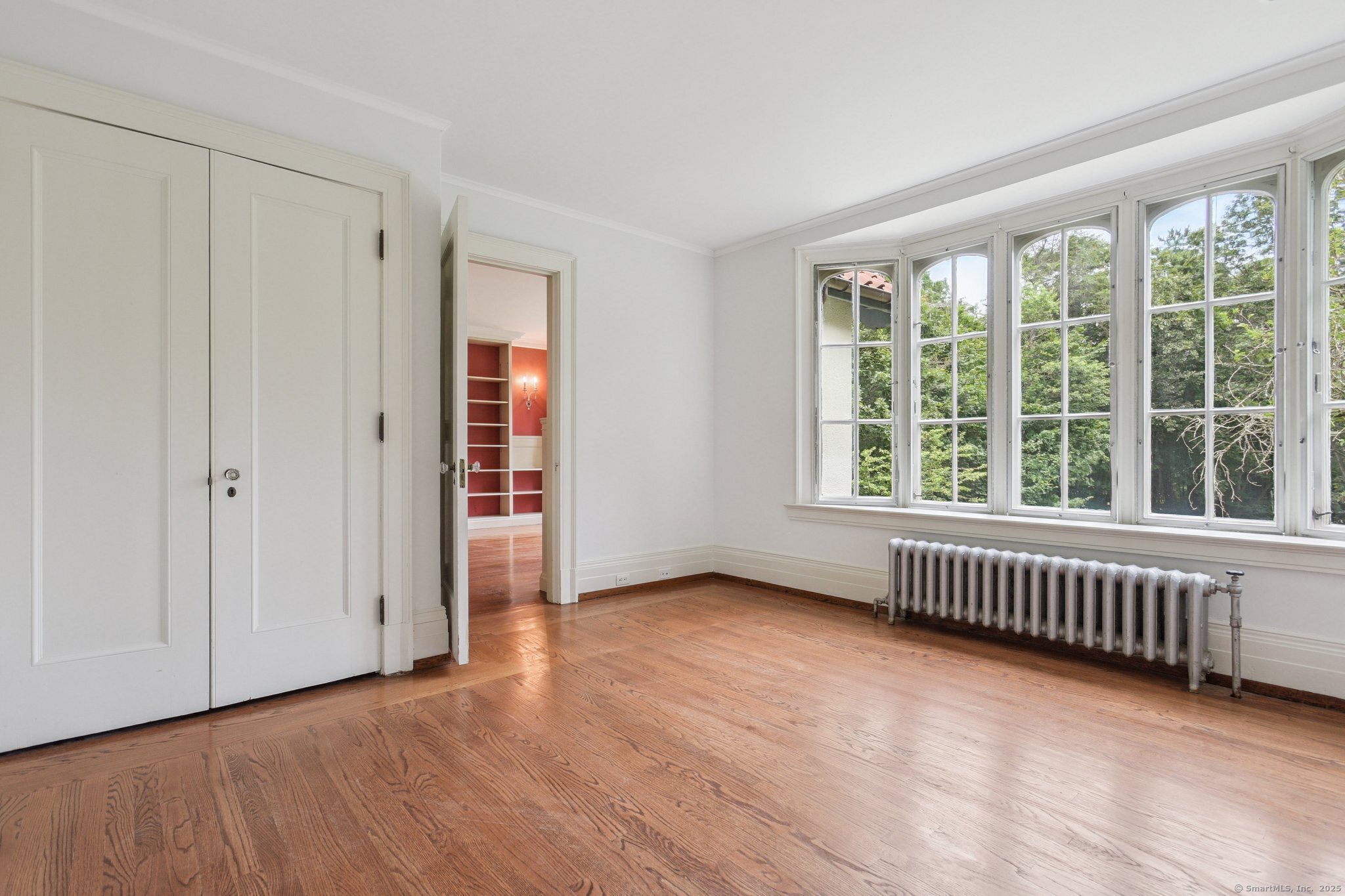 1056 Whitney Avenue Hamden, CT 06517 - Photo 30 of 40 a view of an empty room with wooden floor and a window