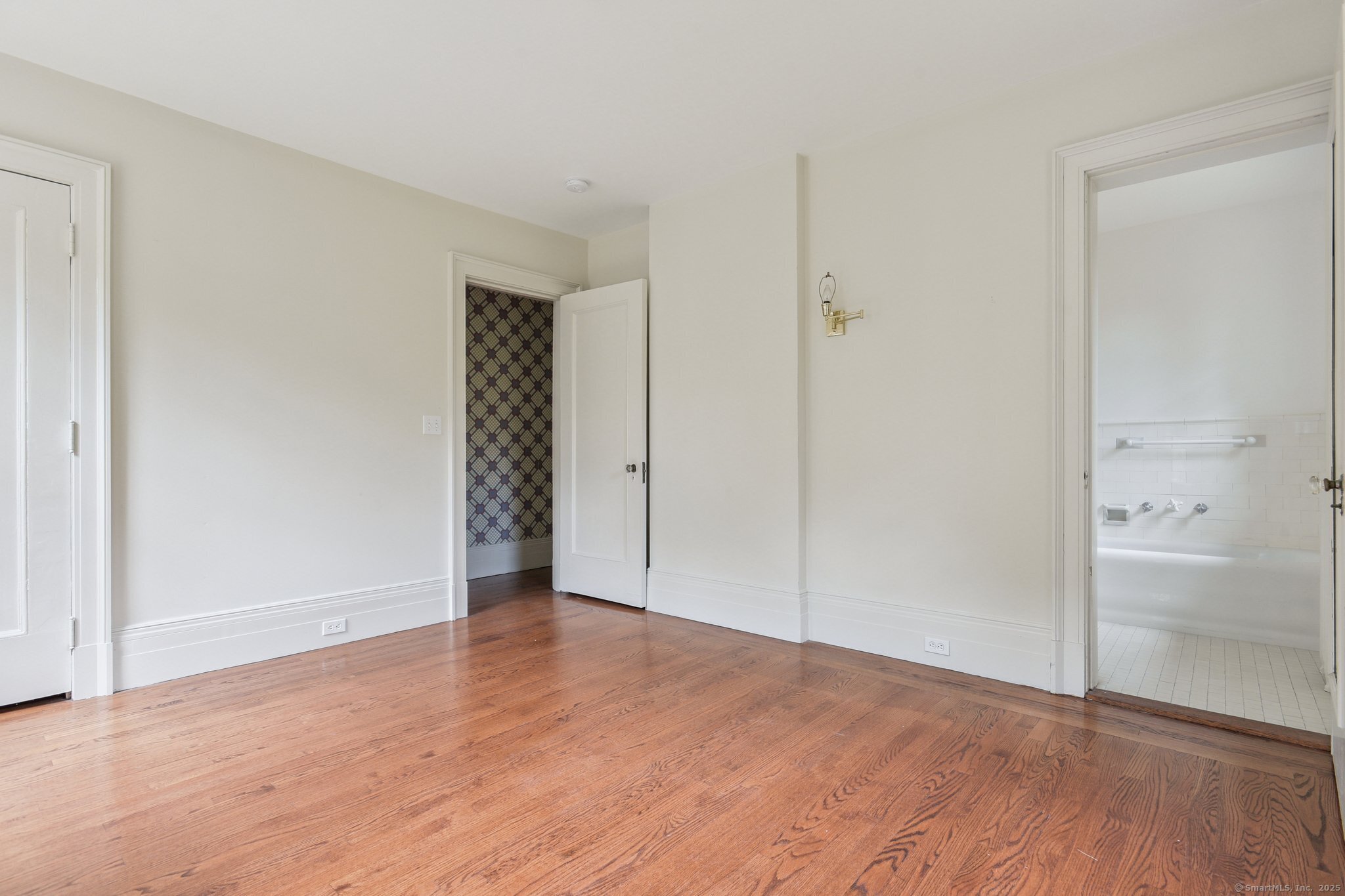1056 Whitney Avenue Hamden, CT 06517 - Photo 32 of 40 a view of an empty room with closet and wooden floor