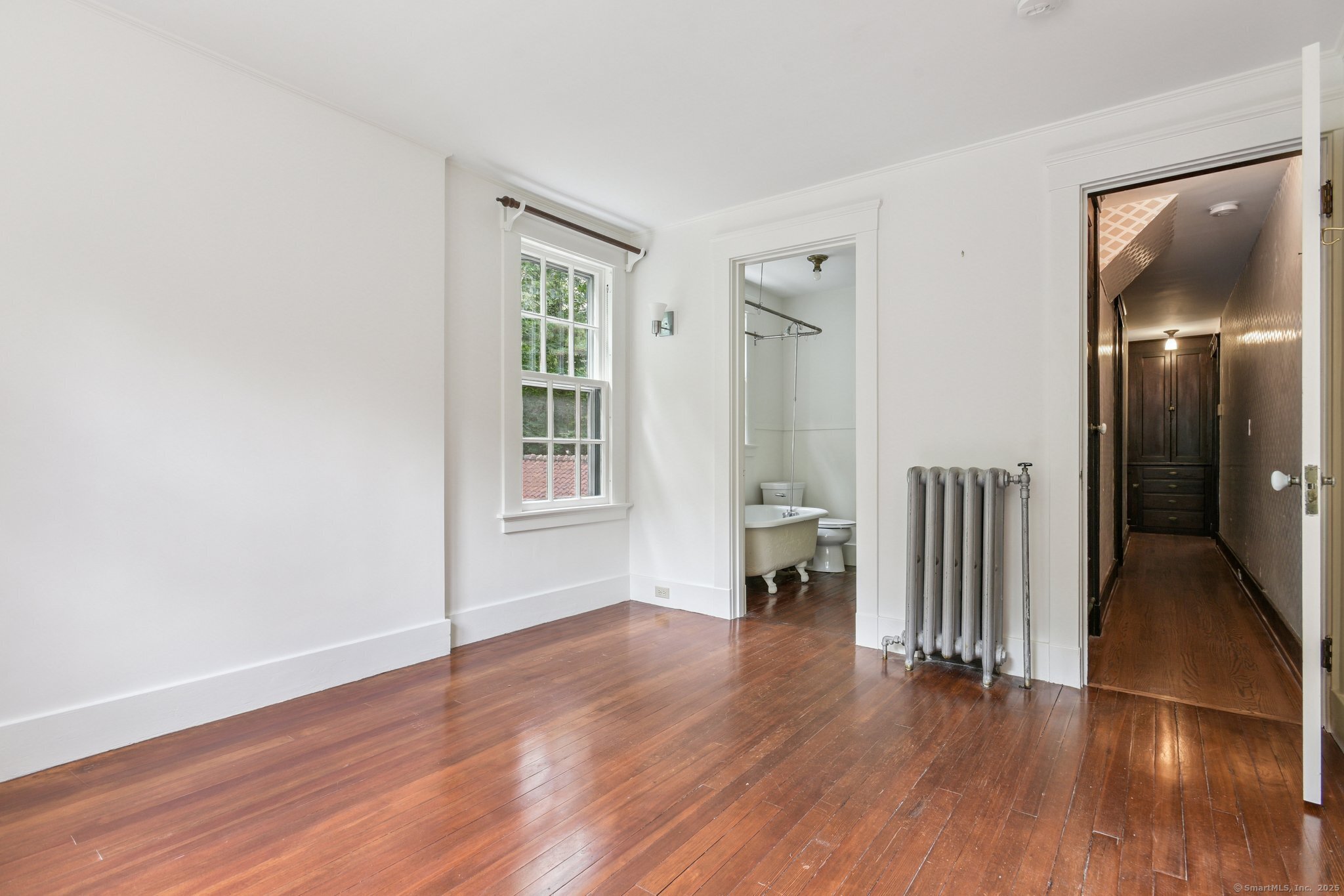 1056 Whitney Avenue Hamden, CT 06517 - Photo 35 of 40 an empty room with wooden floor and a bathroom