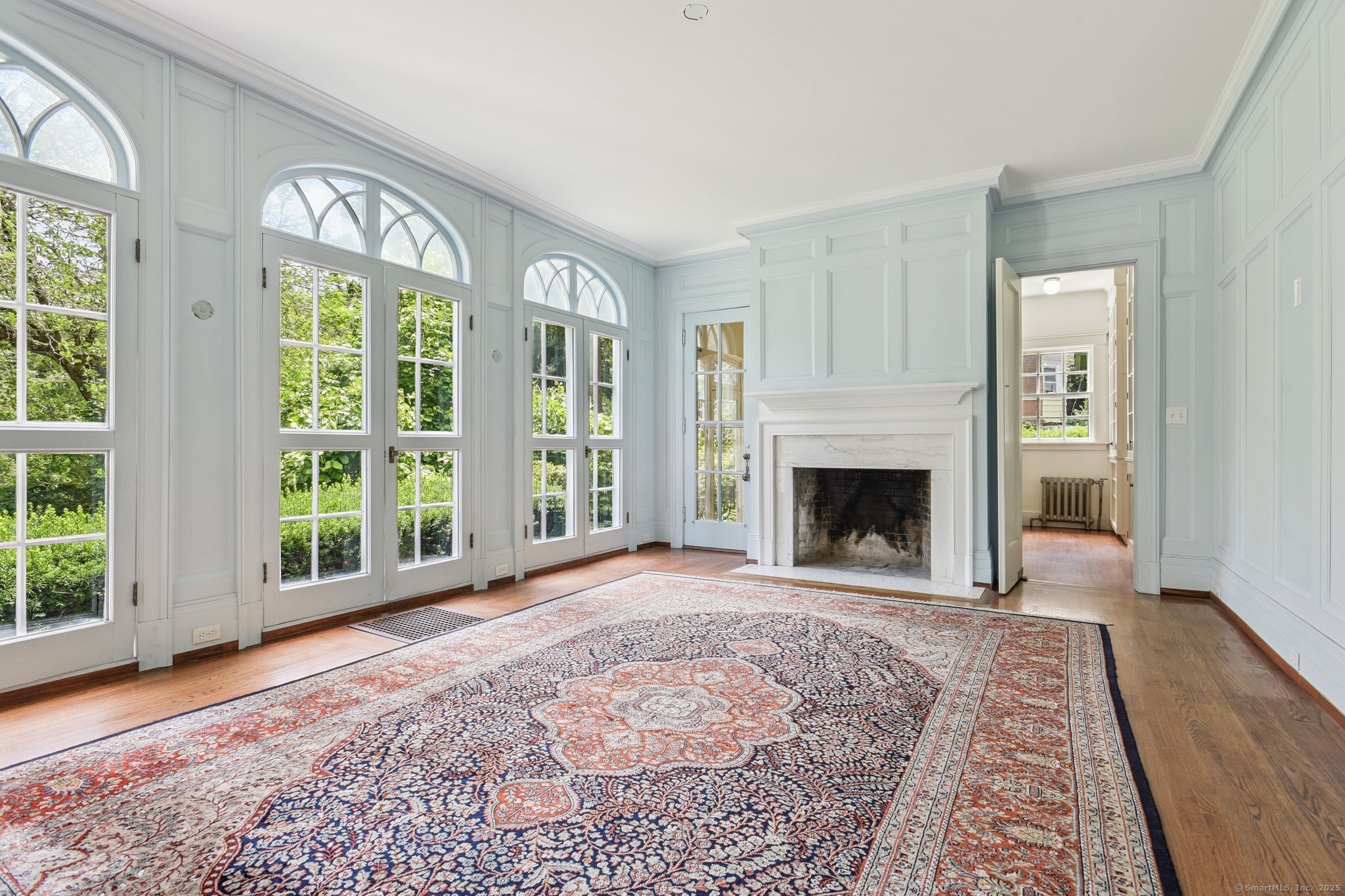1056 Whitney Avenue Hamden, CT 06517 - Photo 9 of 40 a view of an empty room with a fireplace and a window