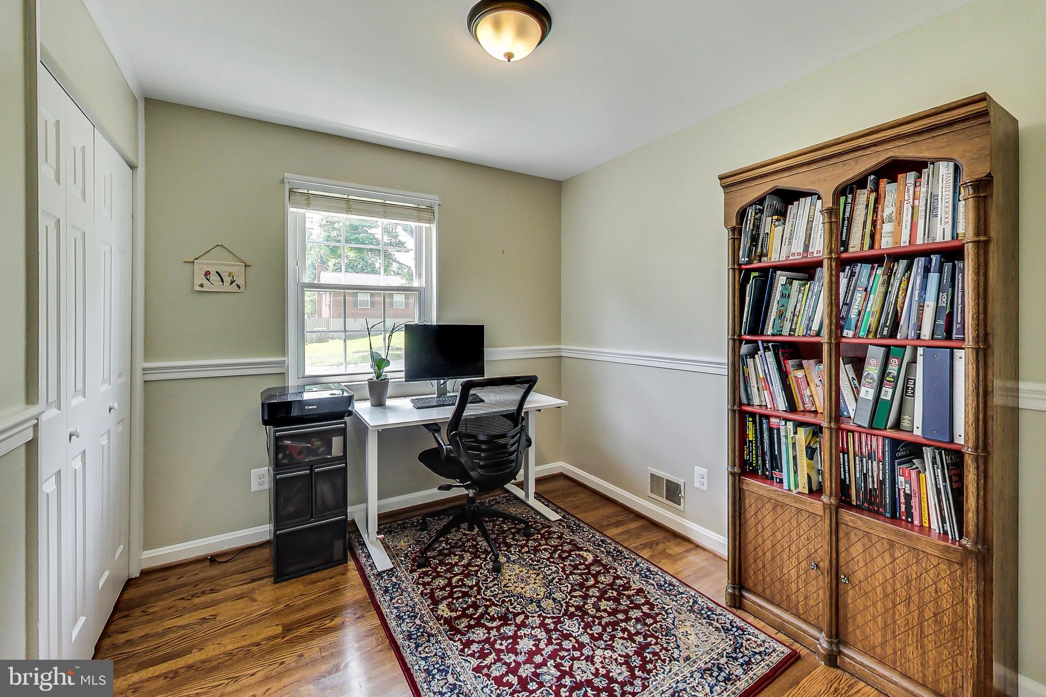 4715 Oxbow Road Rockville, MD 20852 - Photo 15 of 35 a view of a workspace with furniture and a bookshelf