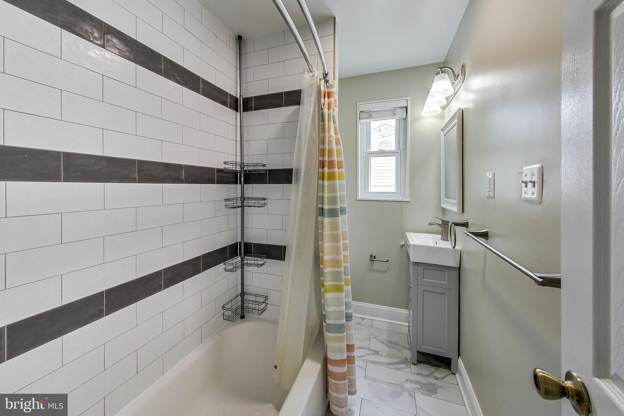 4715 Oxbow Road Rockville, MD 20852 - Photo 17 of 35 a bathroom with a tub and a shower