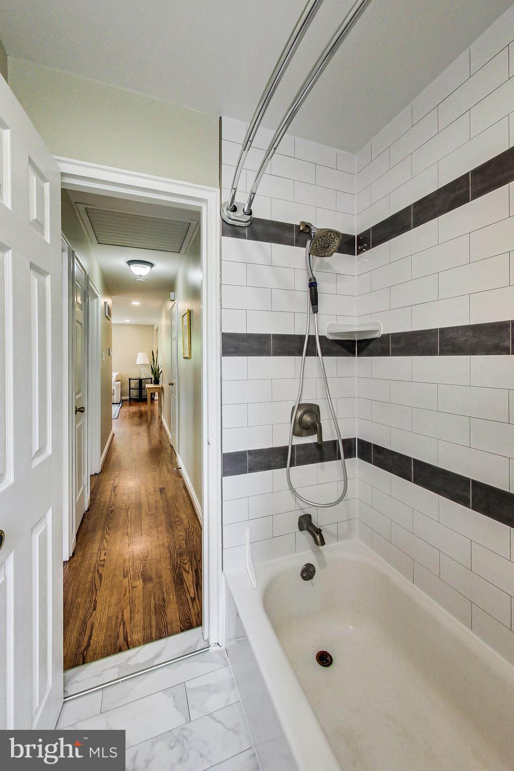 4715 Oxbow Road Rockville, MD 20852 - Photo 18 of 35 a bathroom with a tub and shower