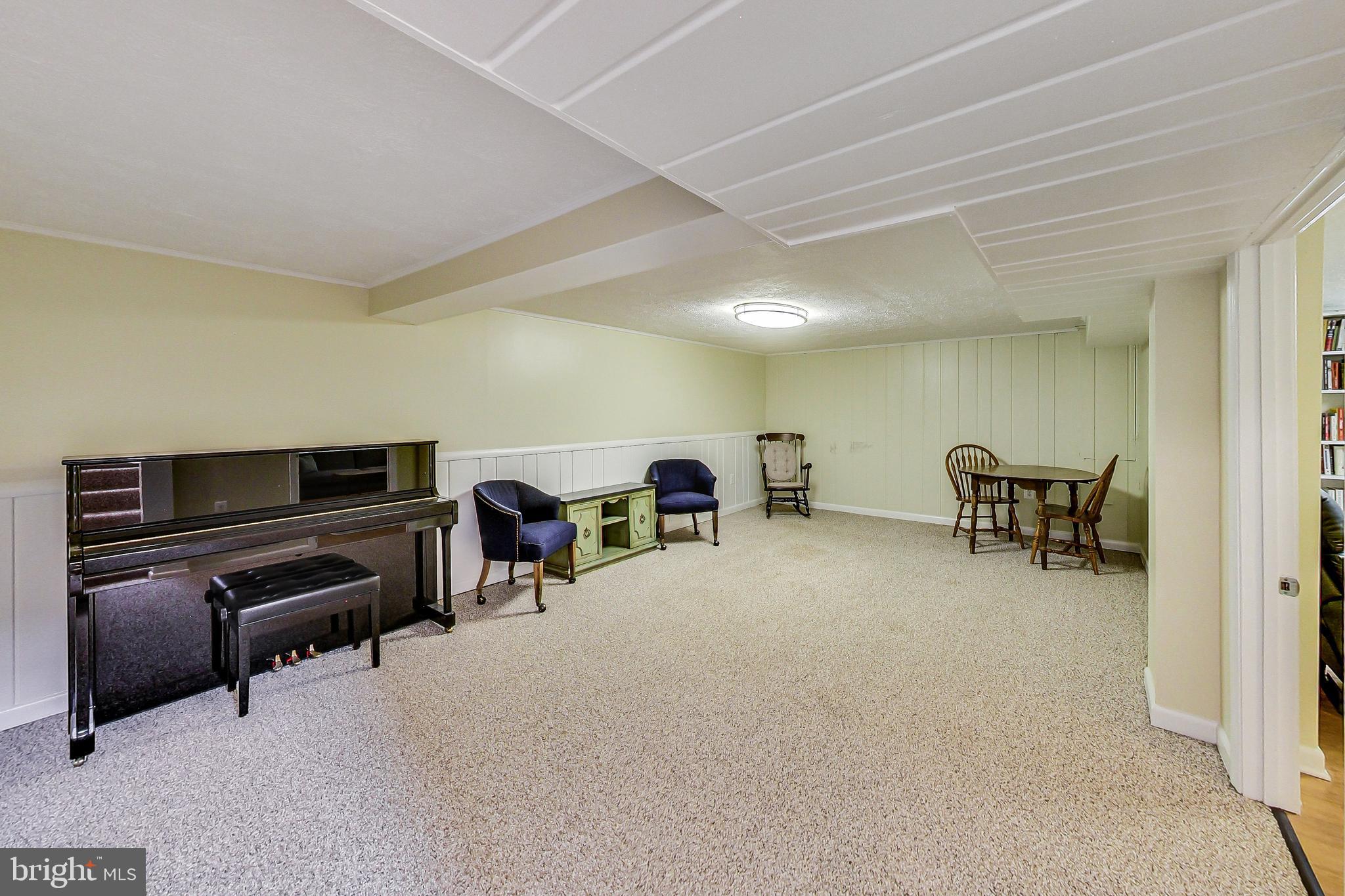 4715 Oxbow Road Rockville, MD 20852 - Photo 19 of 35 a living room with furniture and a flat screen tv