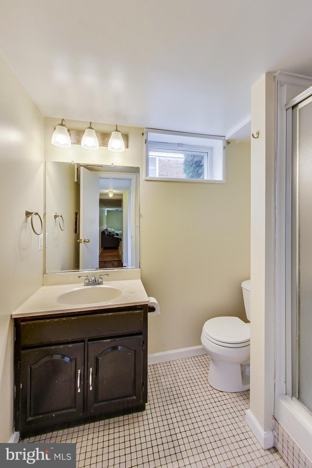 4715 Oxbow Road Rockville, MD 20852 - Photo 25 of 35 a bathroom with a sink a toilet and a mirror