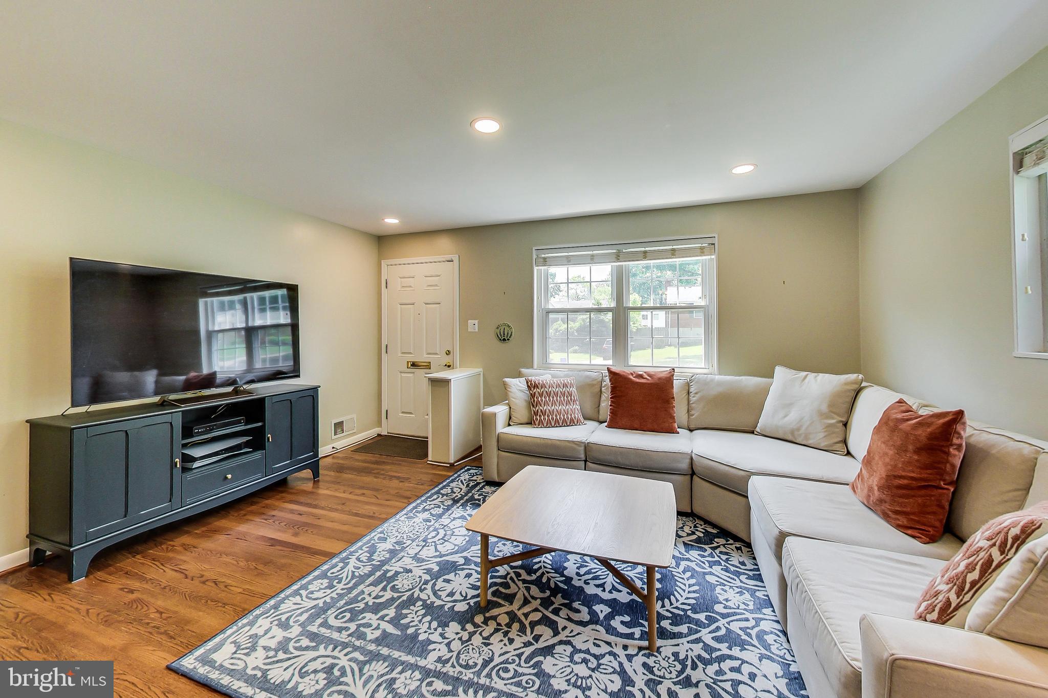 4715 Oxbow Road Rockville, MD 20852 - Photo 3 of 35 a living room with furniture and a flat screen tv