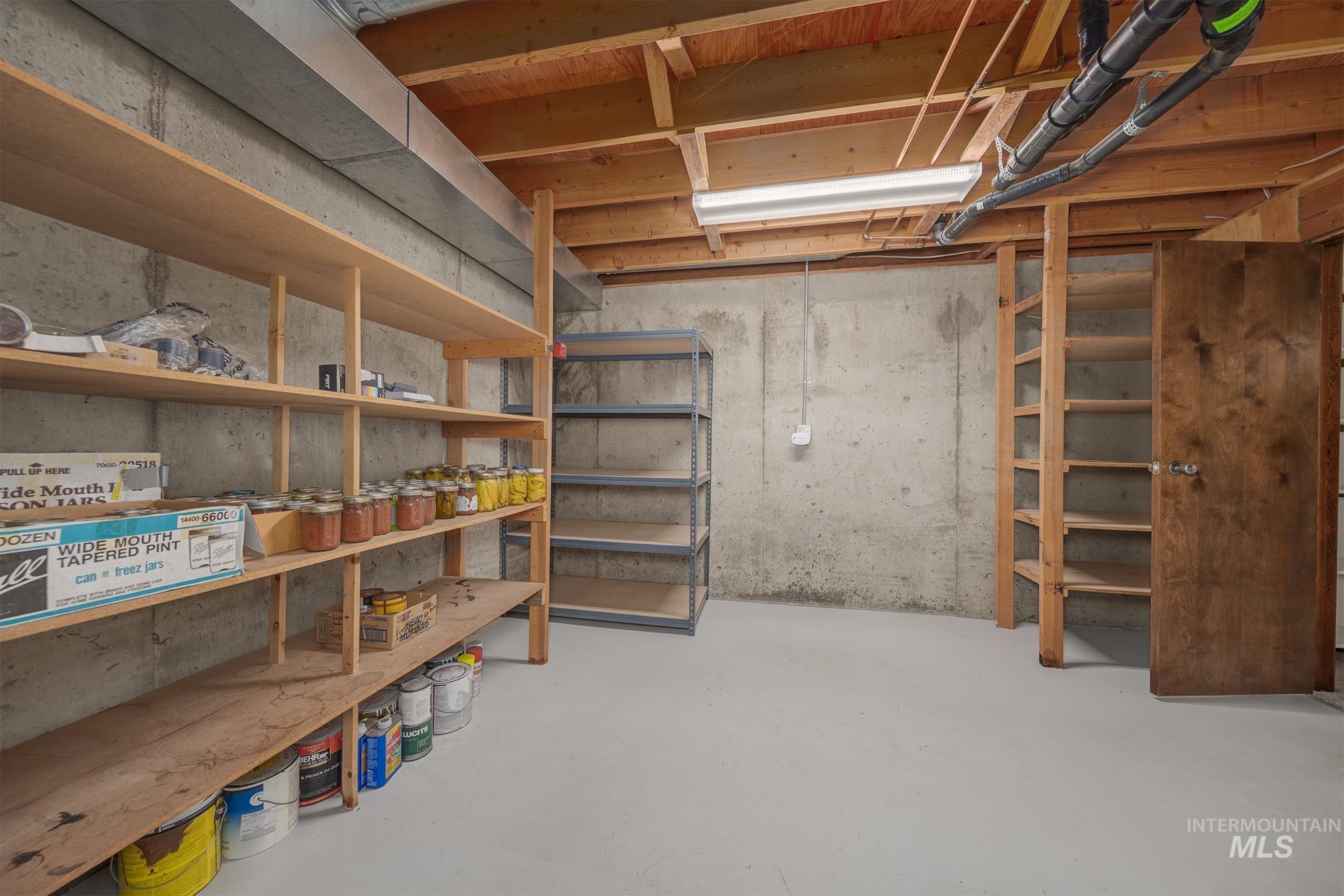 1493 Cove Road Weiser, ID 83672 - Photo 36 of 50 Utility area featuring concrete walls, exposed wood ceiling joists, and a painted concrete floor