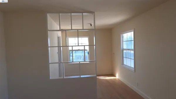 an empty room with windows and closet