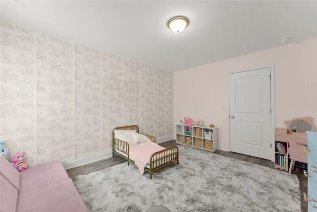 a bedroom with furniture and a rug