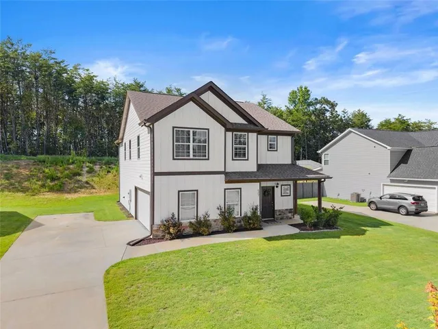 a front view of a house with swimming pool having outdoor seating