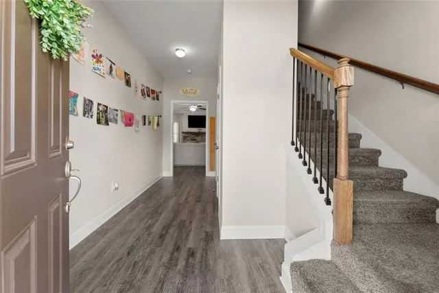 a view of entryway with stairs and wooden floor