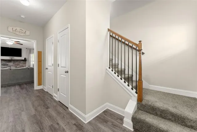 a view of a livingroom with wooden floor and stairs